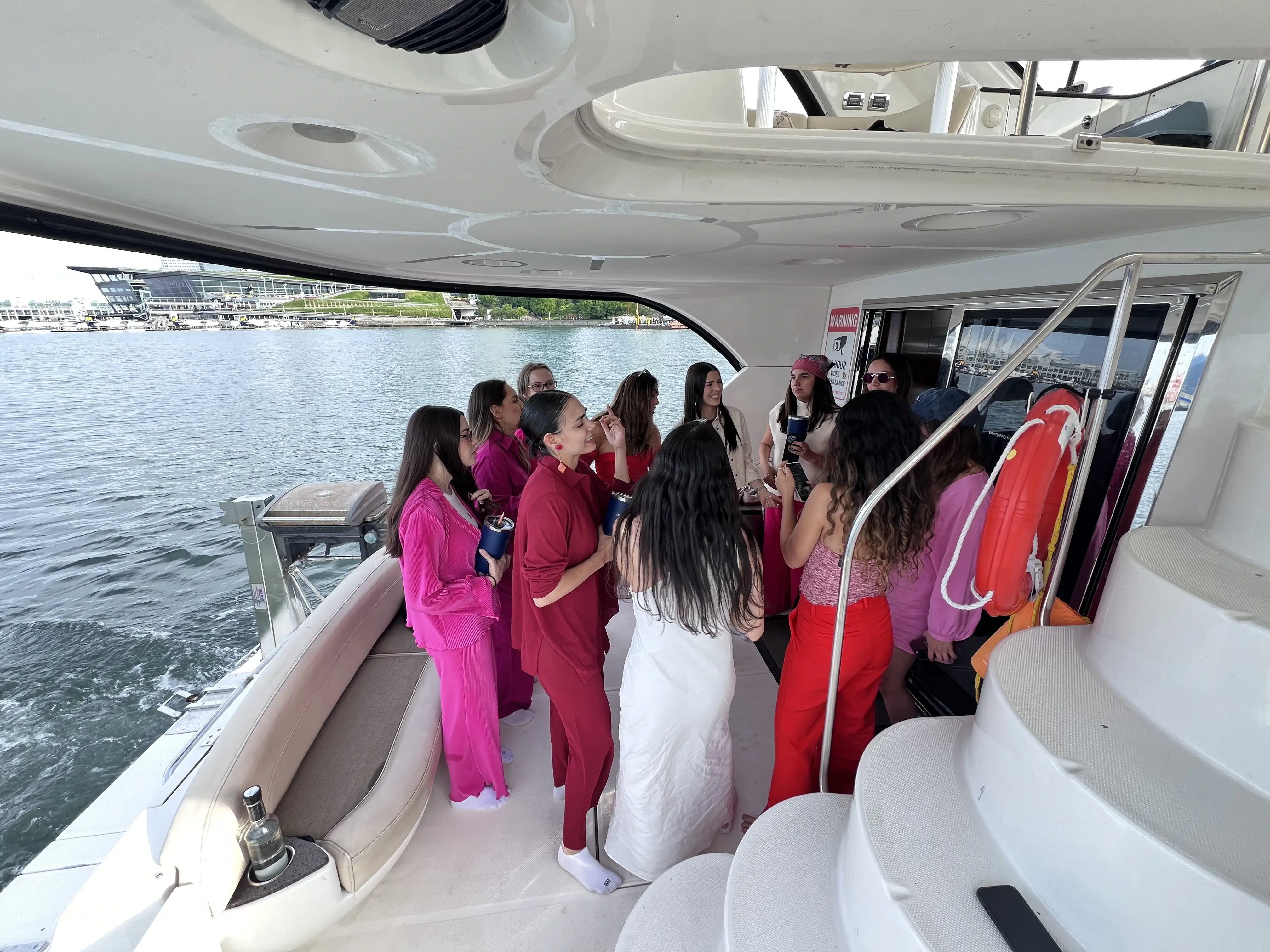 A party group in matching outfits gathered in the cabin of a yacht